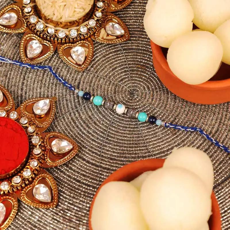 Evil Eye Rakhi and Tin Rasgulla - Gifts gift from Buy Any Flowers Dubai in Al Quoz Industrial Area 4, Dubai, UAE