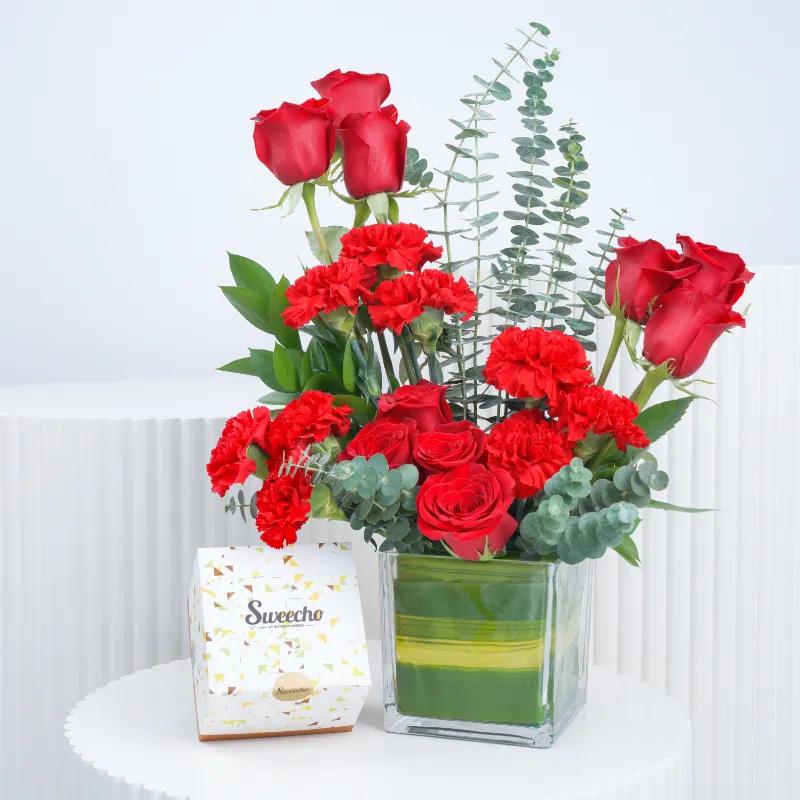 Eternal Red Roses and Carnations in Vase with Chocolates - Gift Sets gift from Buy Any Flowers Dubai in Al Quoz Industrial Area 4, Dubai, UAE