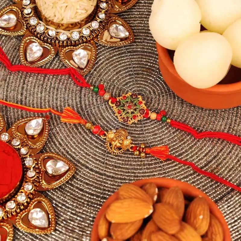 designer-and-ganesha-rakhi-with-tin-rasgulla-and-almonds-set-of-2_1.webp