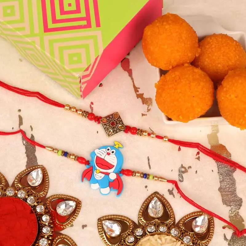 antique-kundan-and-doremon-rakhi-with-motichoor-laddoo-set-of-2_1.webp