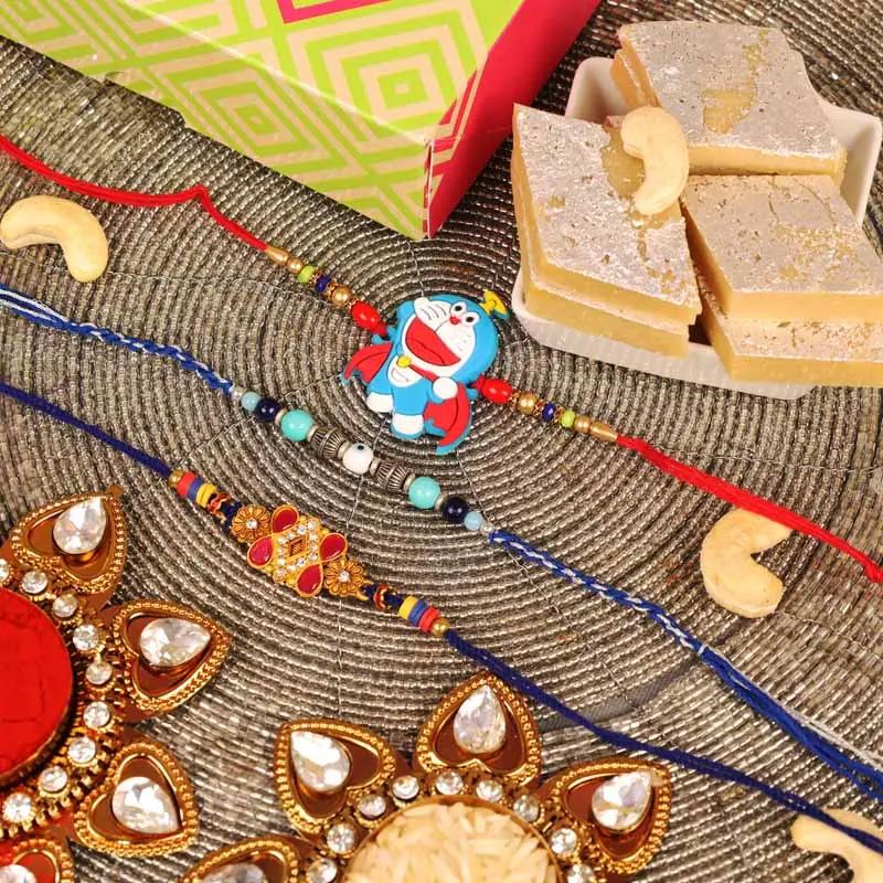 evil-eye-kundan-and-doremon-rakhi-with-kaju-katli-set-of-3_1.webp