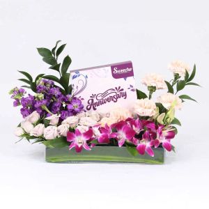 wishes-flowers-and-aniiversary-chocolates-arrangement_1.webp