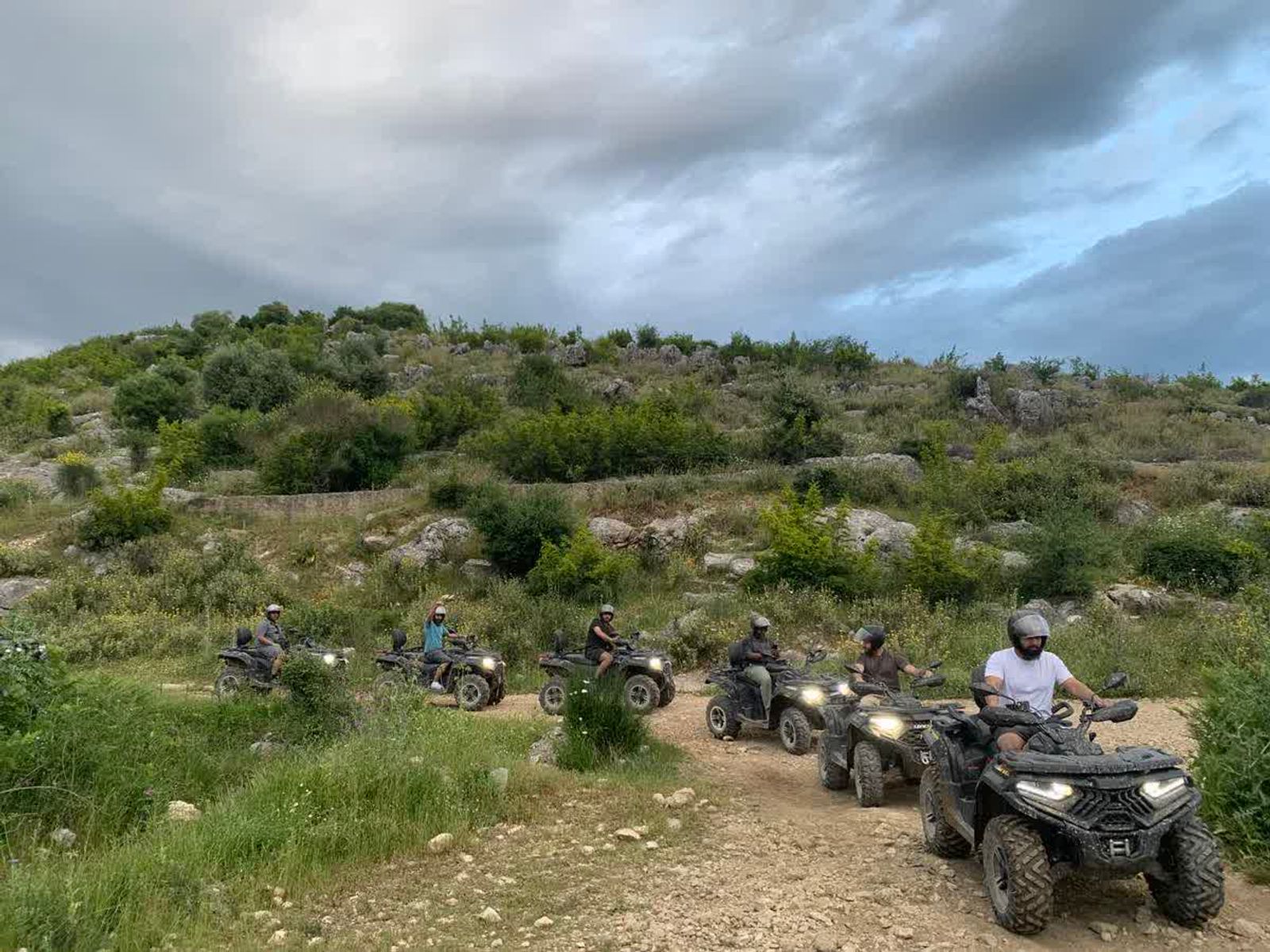 Riders on a rugged hillside with ancient dry-stone terraces near Finiq