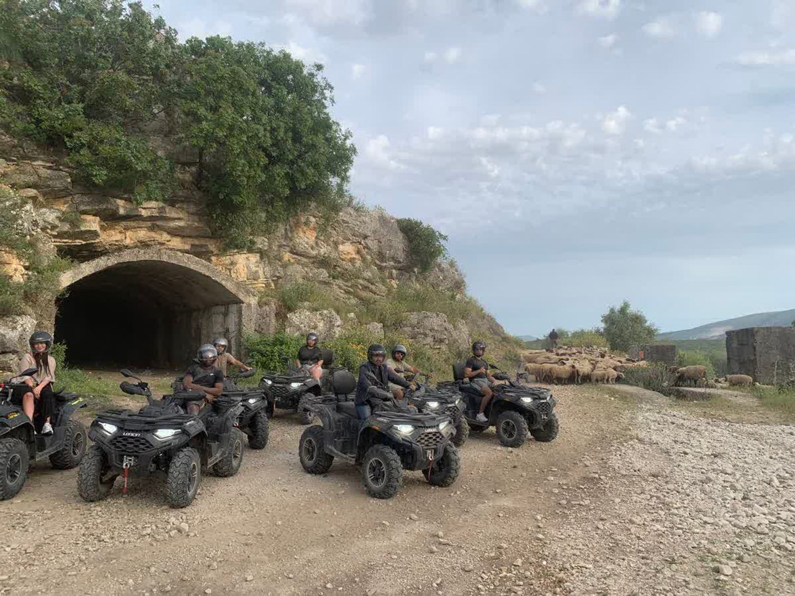 Quad riders beside an old stone tunnel in the countryside near Butrint and Saranda