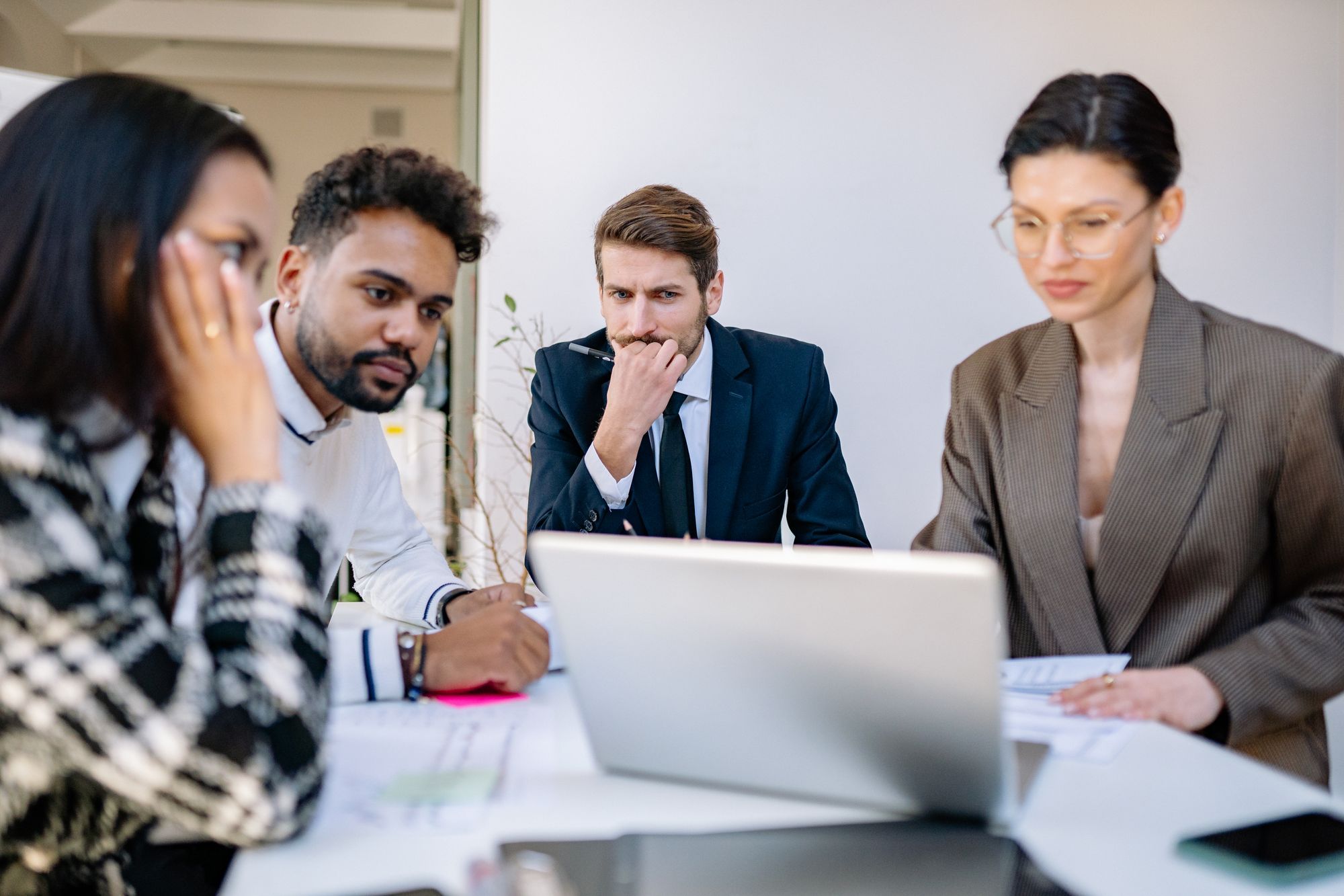 A team in an office looking at a laptop together