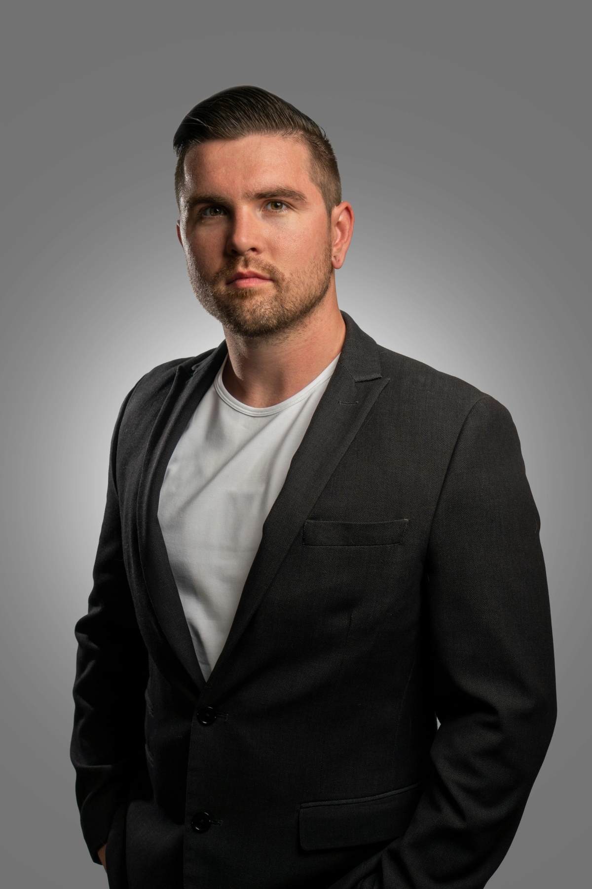 a person posing for a picture agains solid grey backdrop