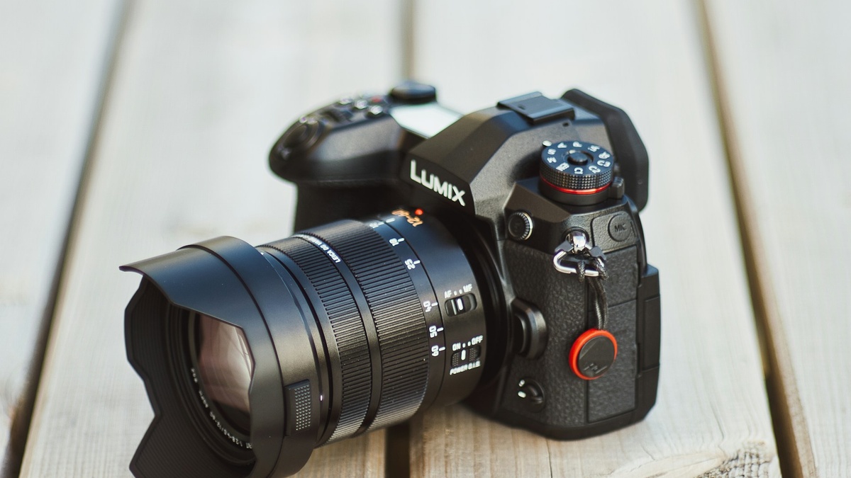 Professional camera on a wooden table, representing headshot photography pricing