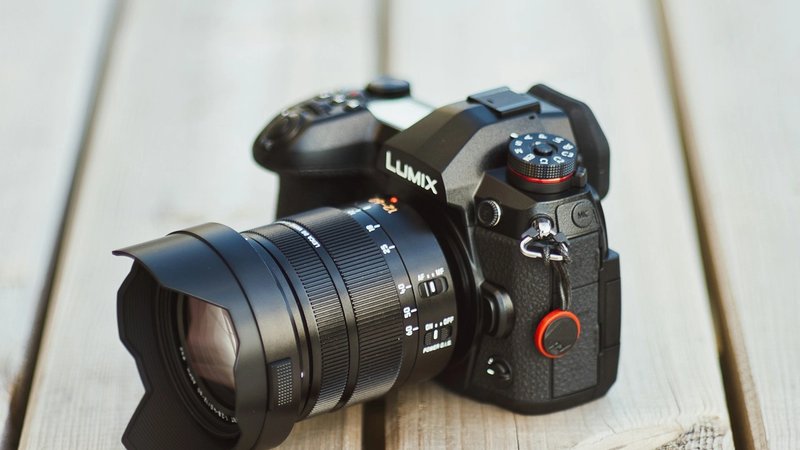 black nikon dslr camera on brown wooden table