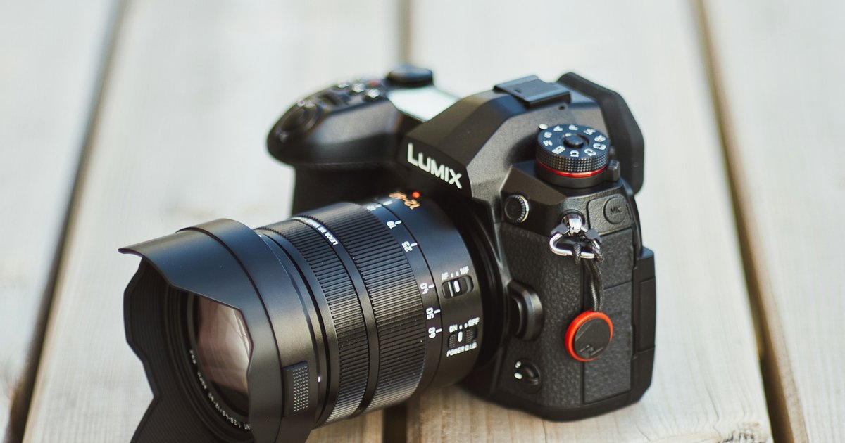 black nikon dslr camera on brown wooden table