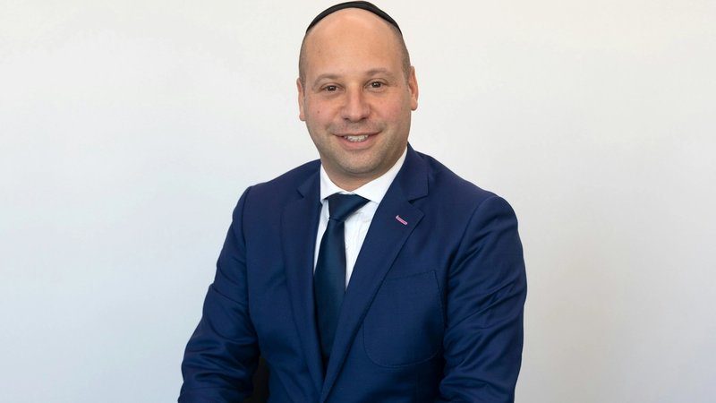 a lawyer headshot of a white man in formal suit with white background