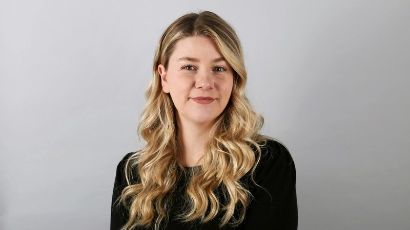 a woman in black dress, standing against white background