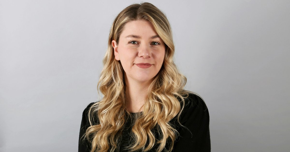 a woman in black dress, standing against white background