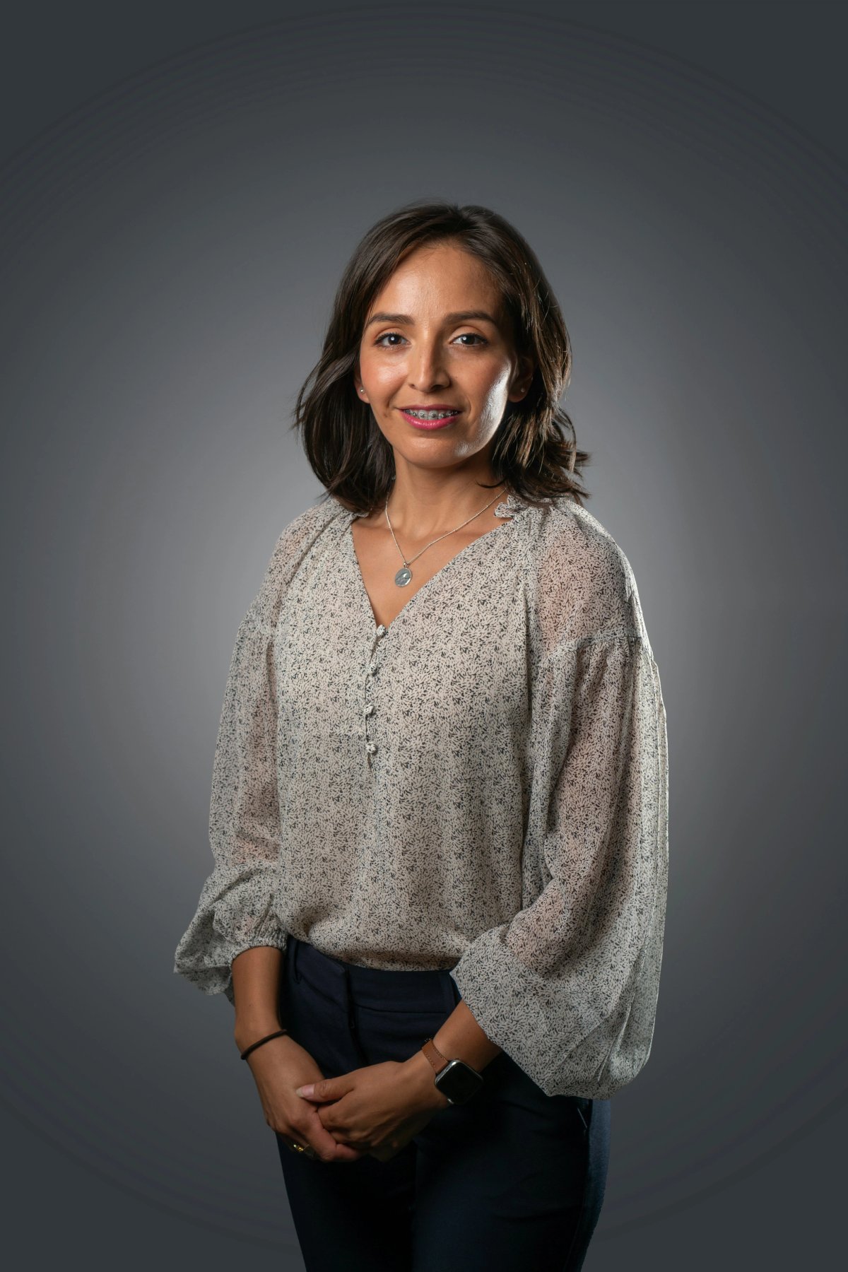 a person posing for a picture agains solid dark grey backdrop