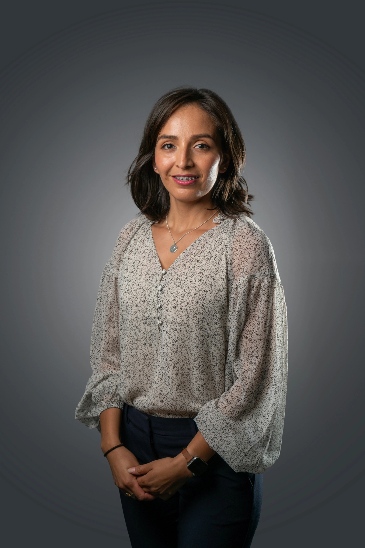 a person posing for a picture agains solid dark grey backdrop