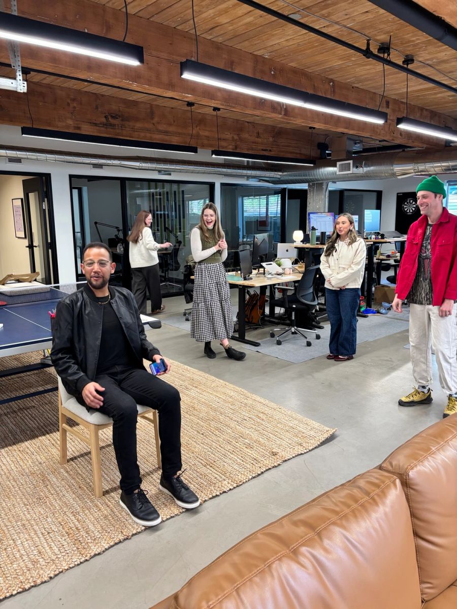 Sproutbox team playing a game around a chair in the middle of the office