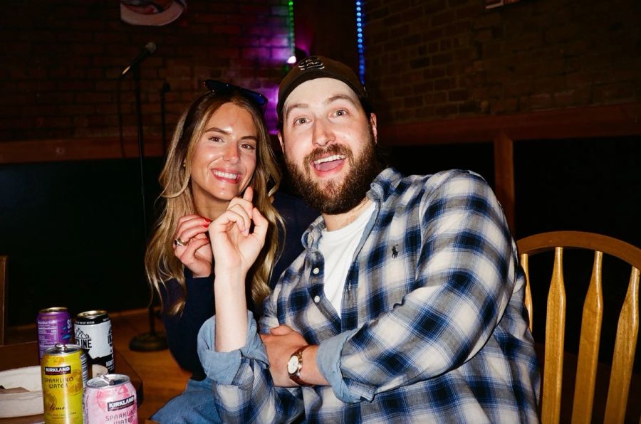 Two Sproutbox teammates laughing at a table during a team night out