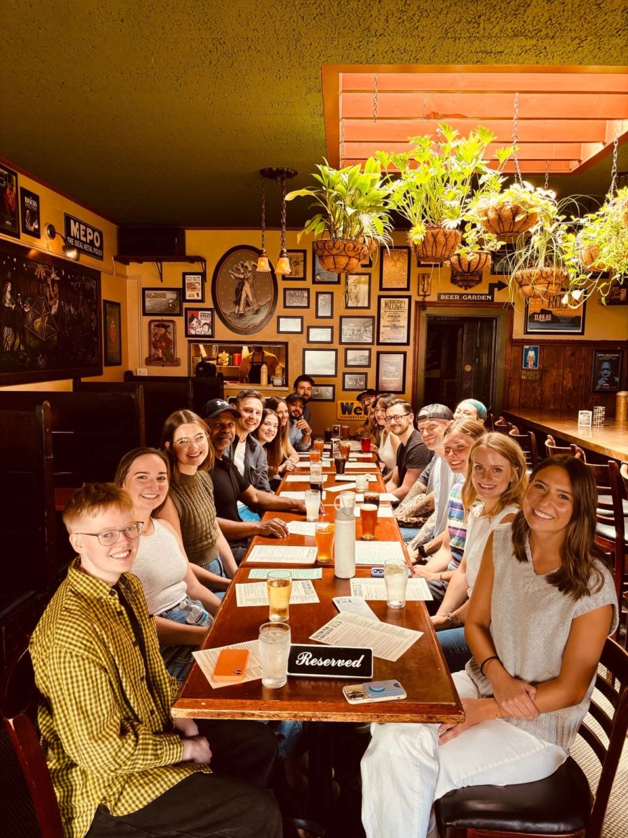 Sproutbox team at a long reserved table in a pub with hanging plants
