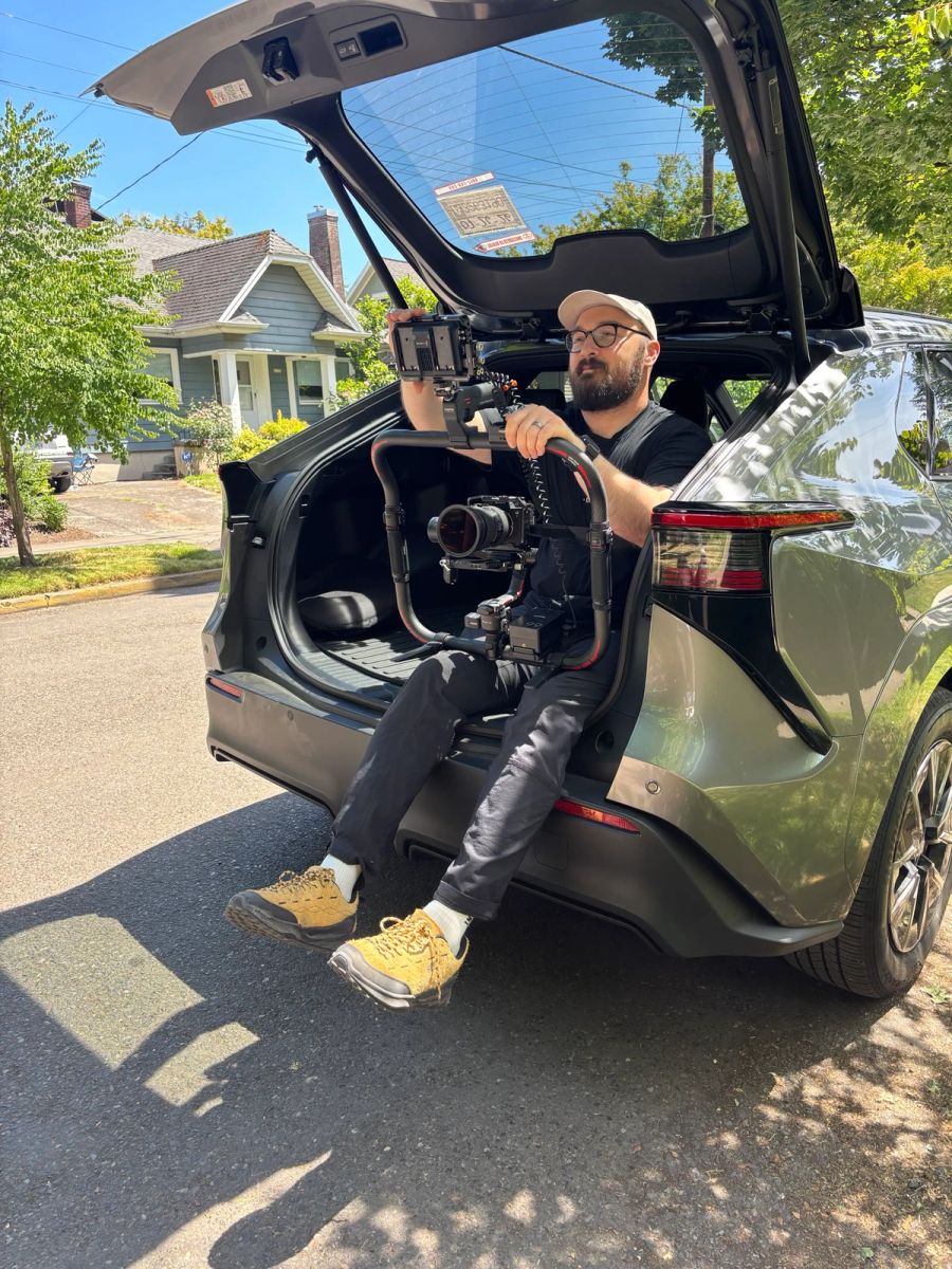Sproutbox videographer rigging a camera gimbal from the back of an SUV on a shoot