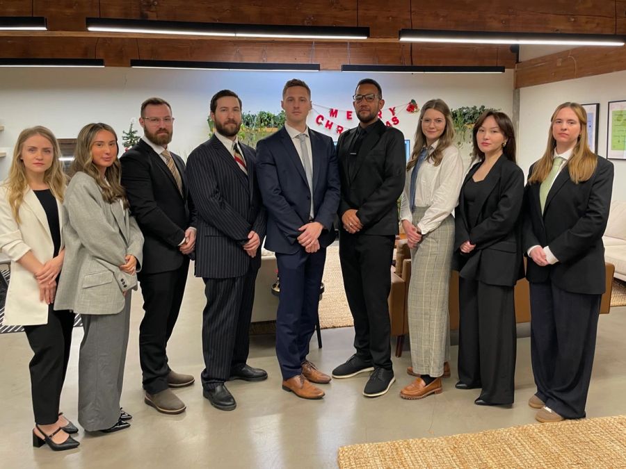 Sproutbox team dressed up in suits for a group photo in the office