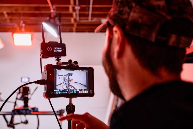 Over-the-shoulder view of a field monitor framing a bicycle shot