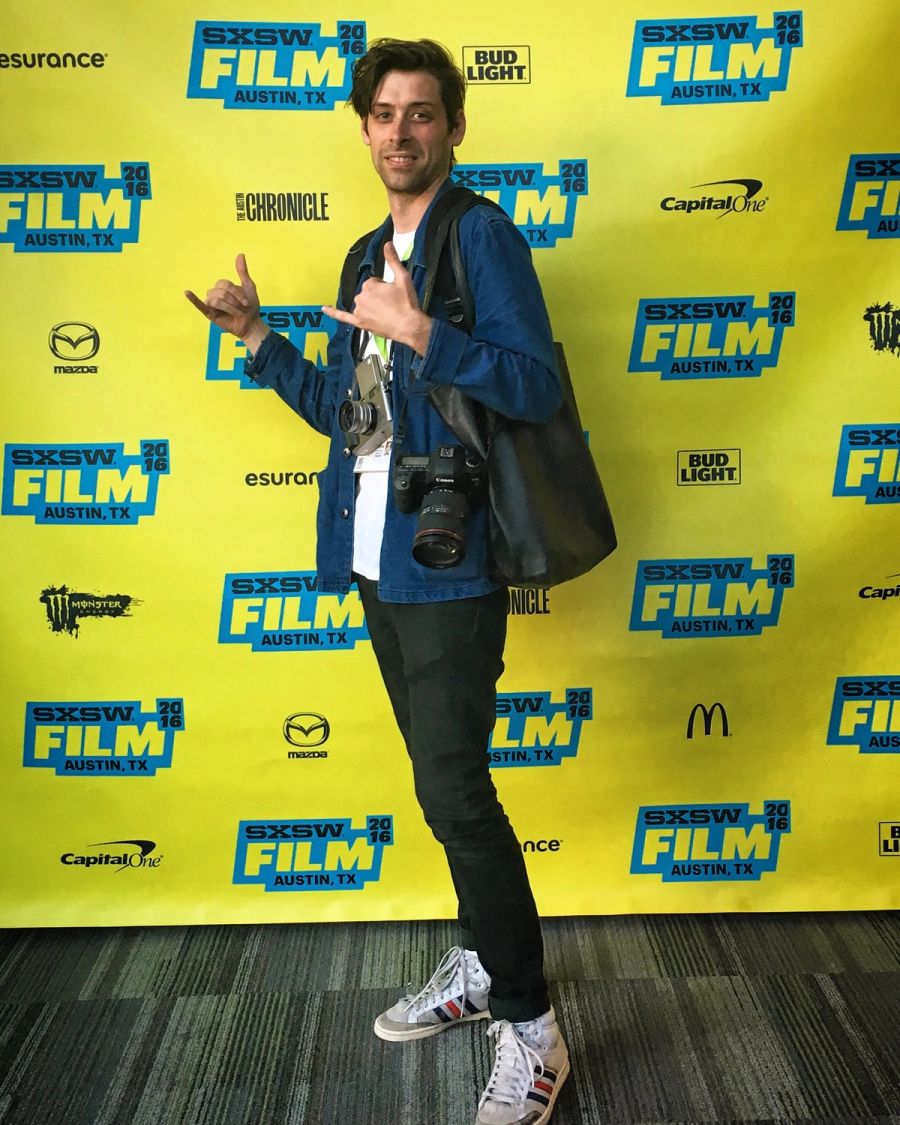 Sproutbox teammate throwing a shaka in front of the SXSW Film step-and-repeat