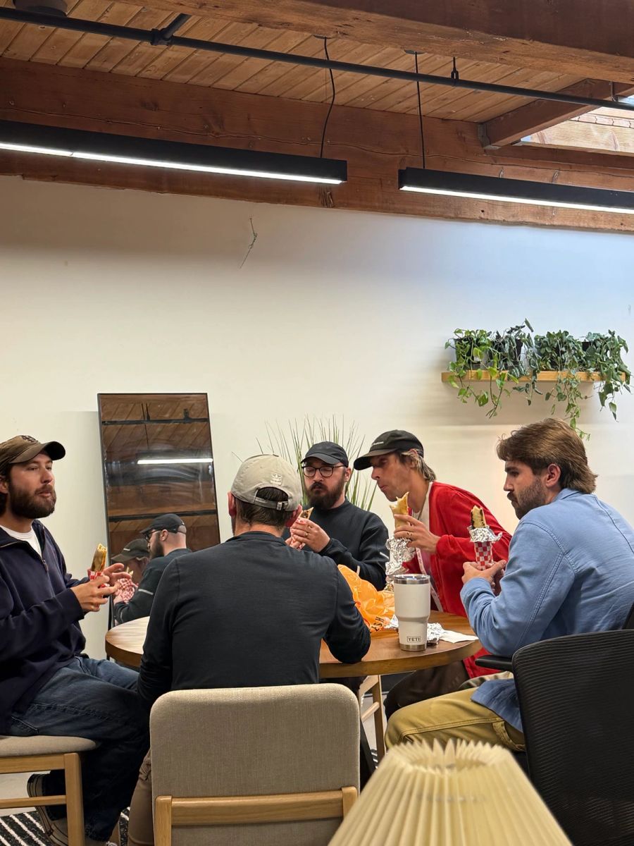 Sproutbox team eating lunch together around an office table