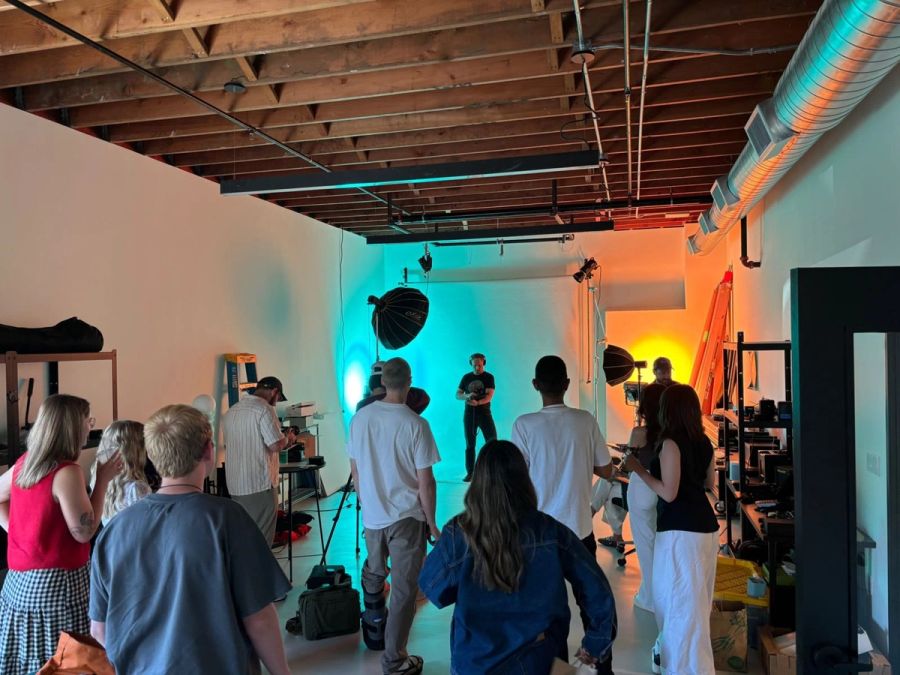 Sproutbox team watching a shoot set up in the studio under teal and orange lights