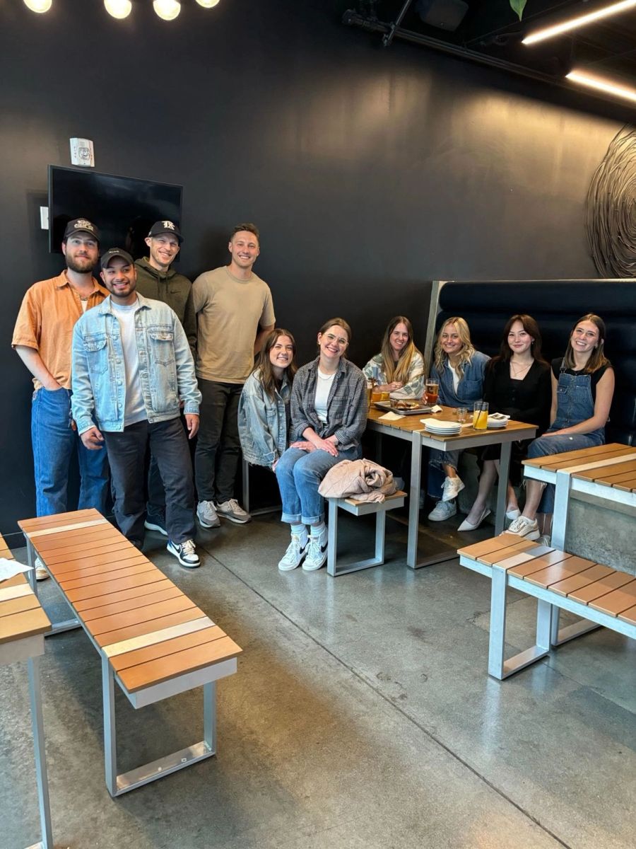 Sproutbox team gathered around a table at a restaurant for a team lunch