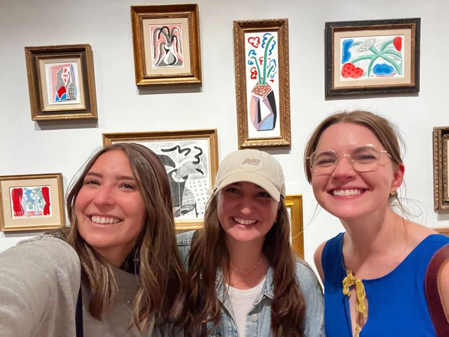 Three Sproutbox teammates taking a selfie in an art gallery