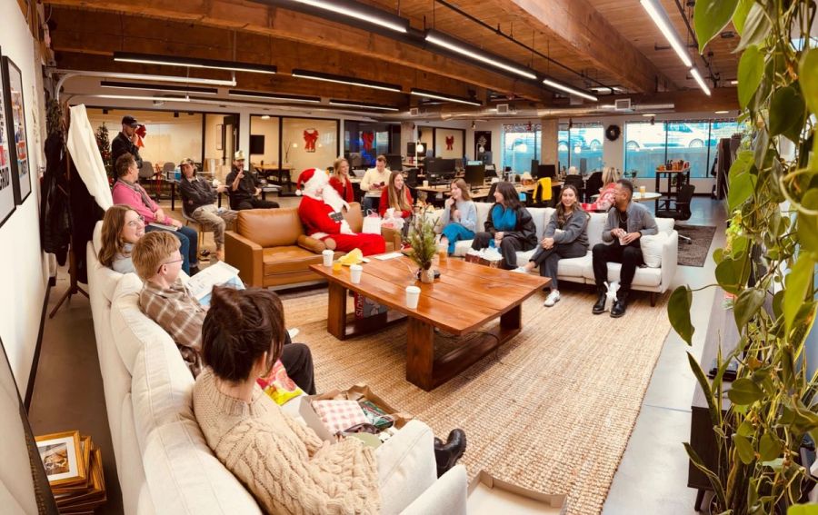 Sproutbox team on the office couches with Santa during the holiday party
