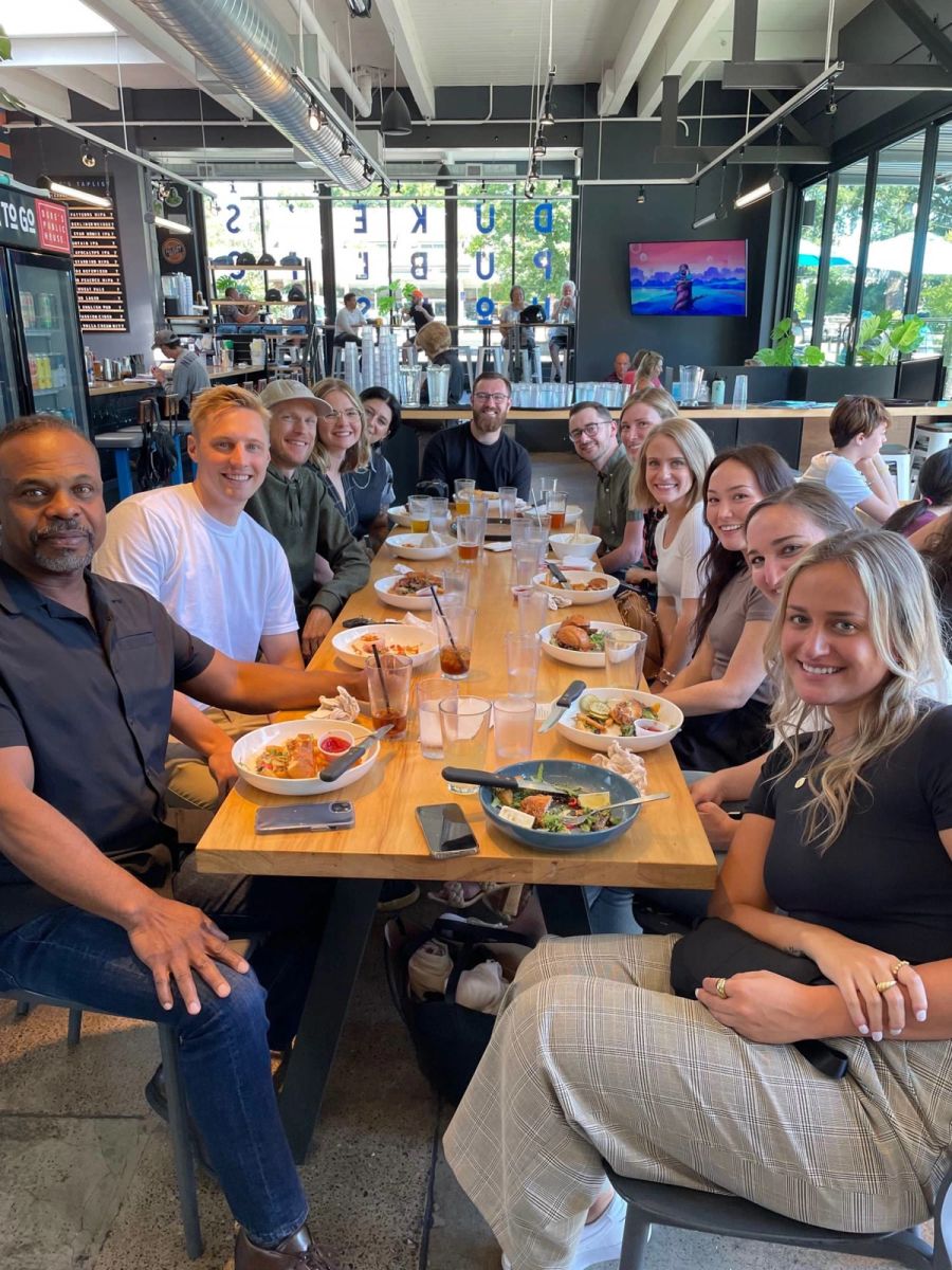 Sproutbox team gathered around a long table for lunch at Duke's Public House
