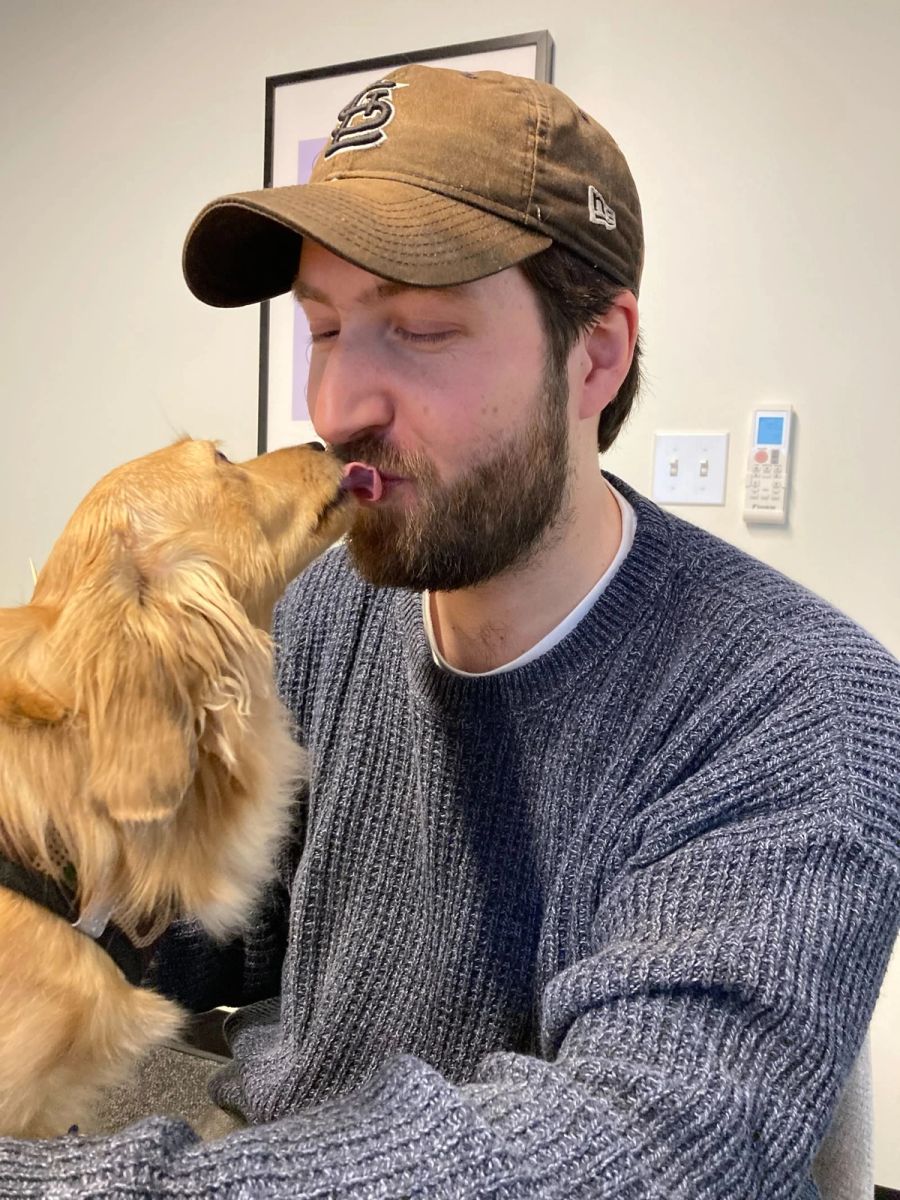 Sproutbox teammate getting a kiss from a golden dog