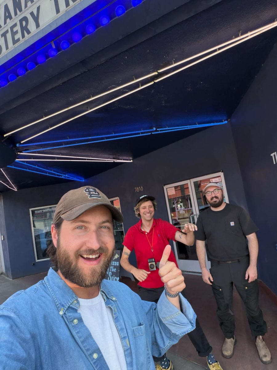 Sproutbox teammate giving a thumbs up in a selfie with two coworkers