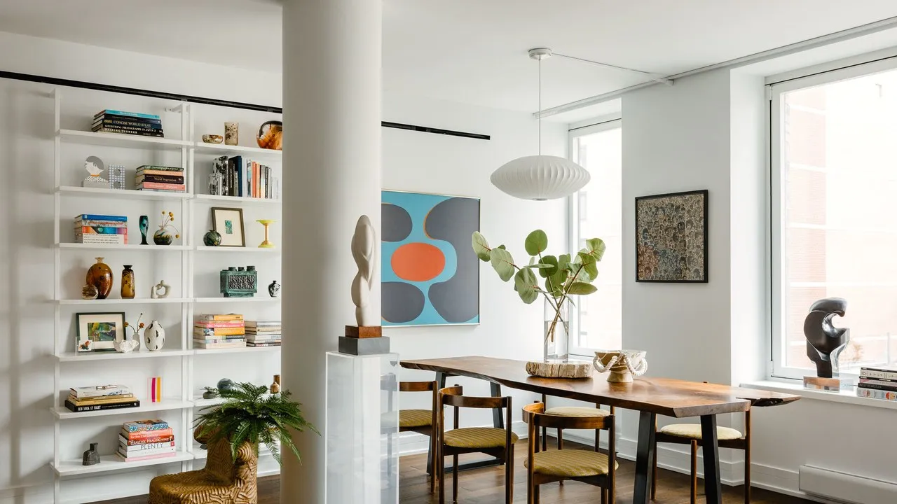 Dinner table with a bookshelf and artifacts
