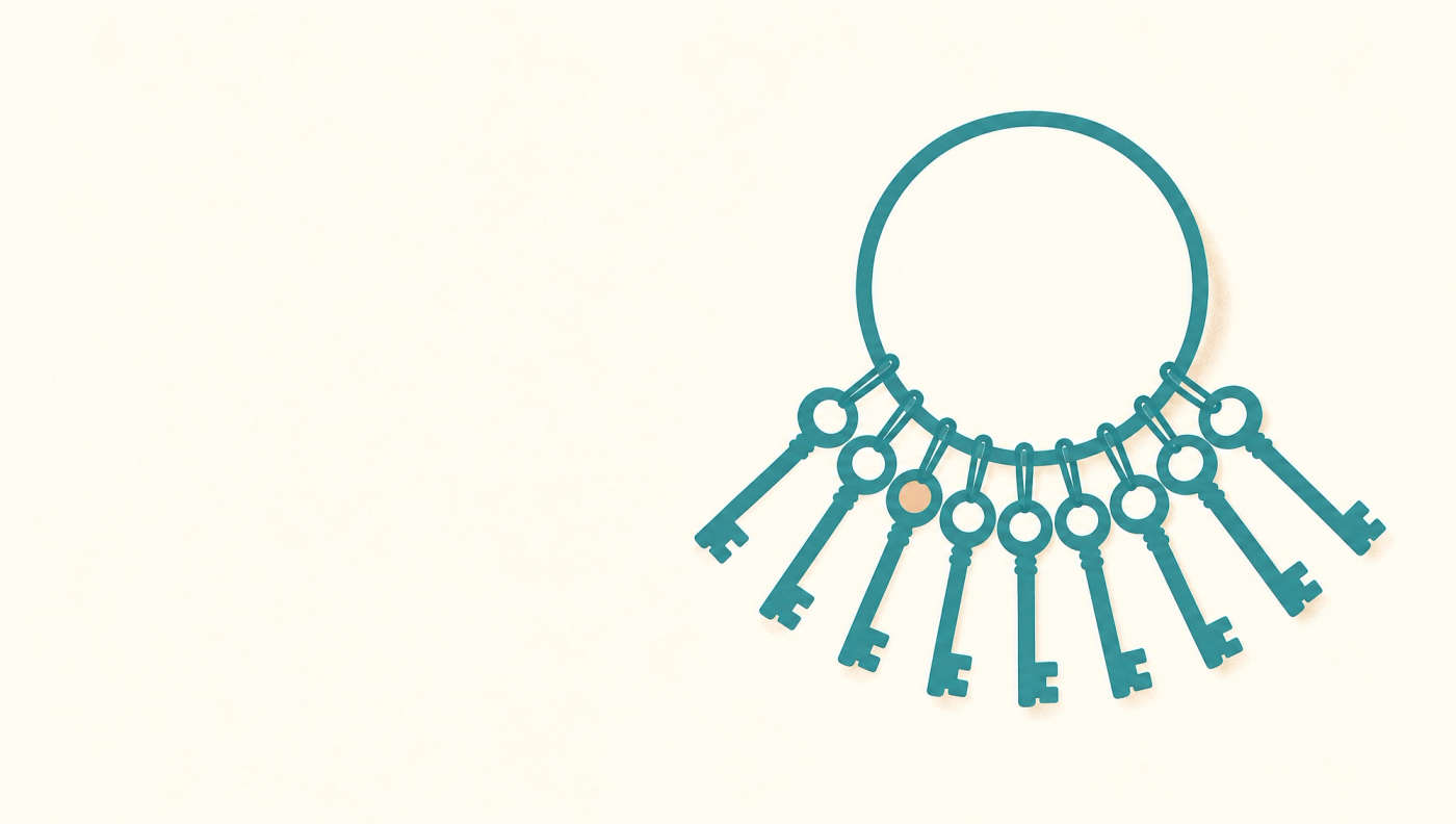 A turquoise key ring crowded with identical keys fanned out below it, one key marked with an apricot dot