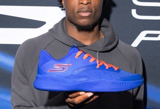 New York Knicks player OG Anunoby's "NYC Blue" Skechers Basketball SKX_Nexus shoe in a blue-and-orange color scheme, available for pre-order.