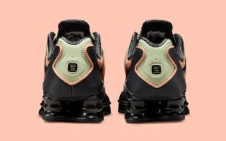Heel angle of the Nike Shox TL in an "Off Noir/Olive Aura/Orange Frost" color scheme.