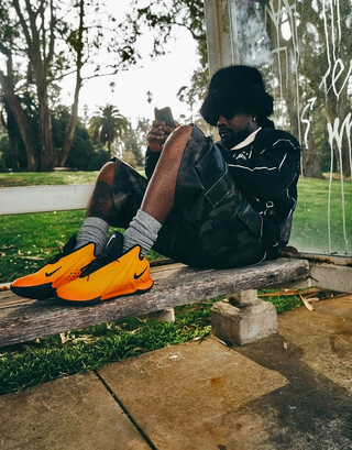 Wale wearing Nike Basketball's G.T. Future in its "Fire" color scheme.