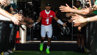 Jalen Hurts in the Air Jordan 1 Mid TD "Electirc Green" via the Eagles. 