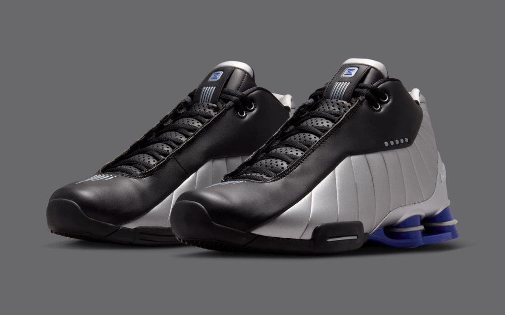 Nike Shox BB4 in Black, Silver, and Lapis colorway, showing the classic Shox column cushioning system and basketball silhouette