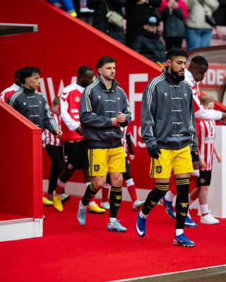 Manchester United players wearing custom viral adidas Chinese New Year Jacket in grey on May 9, 2026.