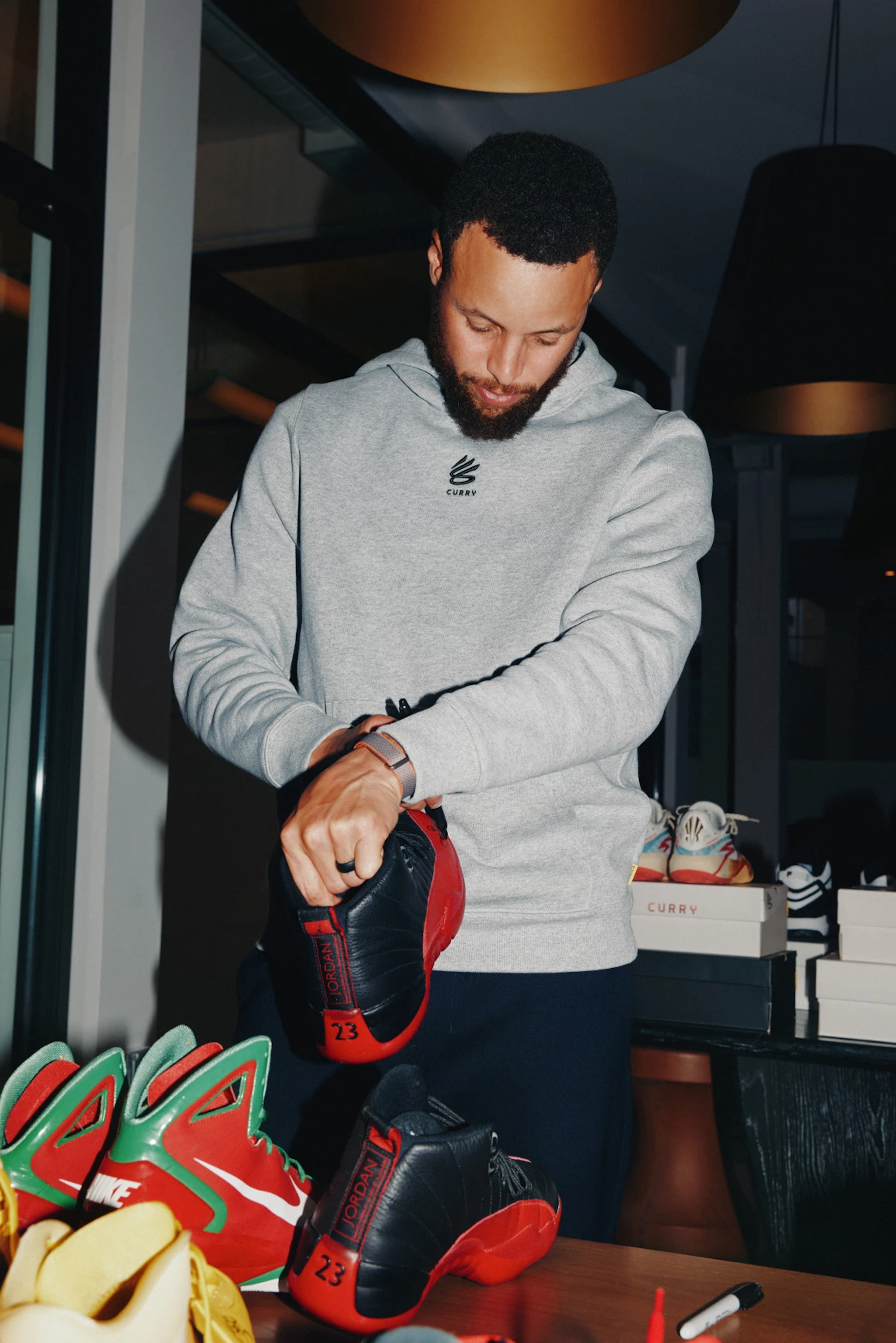 Stephen Curry signing "Flu Game" Air Jordan 12 Retro. Photo via Sotheby's.