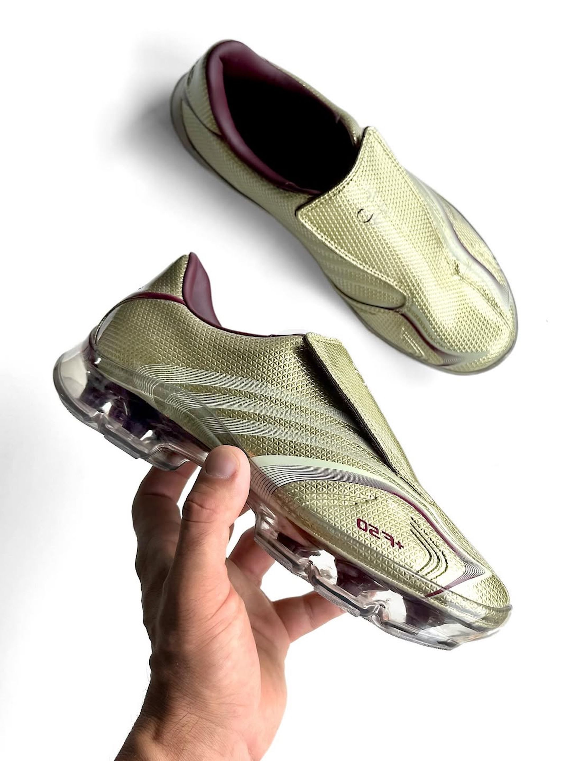 Adidas F50 Adiframe in a "Gold Metallic/Maroon" color scheme.