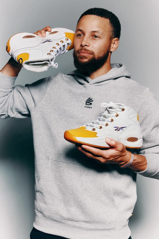 Stephen Curry with the "Yellow Toe" Reebok Question Mid. Photo via Sotheby's.