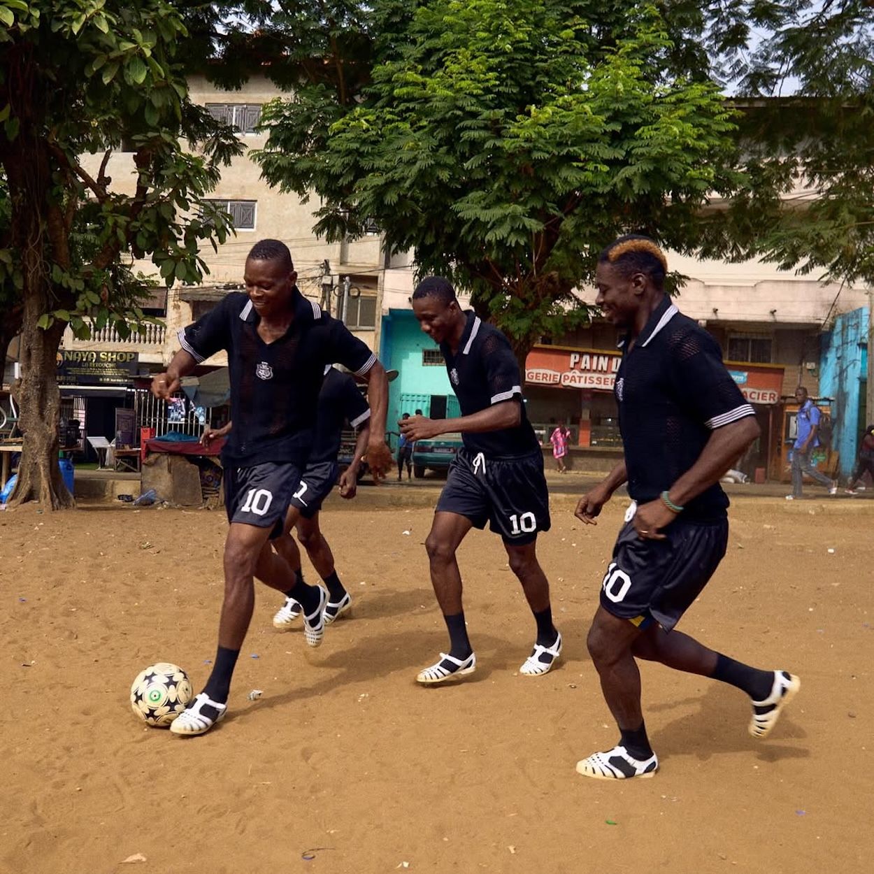 Abidjan locals playing football in lêkê sandals. Photo by Tora San Traoré via Kasi Flavour10.