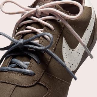 Women's Nike Sprint Sister track-inspired design from 1979 in a "Ridgerock/Ocean Cube/Dark Cinder/Sail" color scheme.