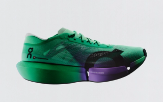 On Cloudboom Strike 2 marathon racer in a "Green/Purple" color scheme.