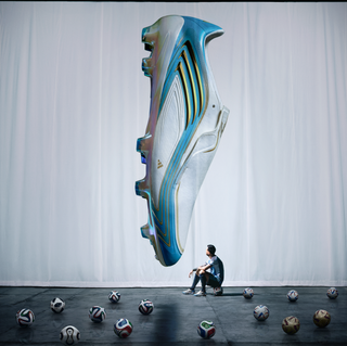 Lionel Messi sitting in front of his "El Último Tango" 2026 World Cup™ F50 boots while surrounded by 17 adidas match balls that represent his 17 World Cup™ goals.