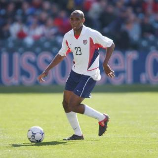 Eddie Pope wearing USMNT's 2002 Home jersey by Nike.