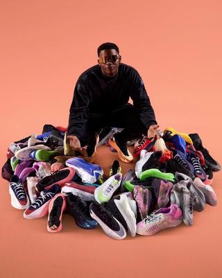 Anthony Edwards surrounded by handfuls of his Adidas Basketball Anthony Edwards 1 (AE 1) releases.